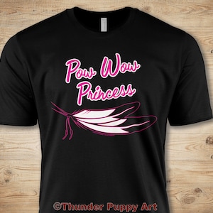 May include: Black t-shirt with the text "Pow Wow Princess" in pink lettering and a pink and white feather design. The text "Thunder Puppy Art" is at the bottom of the shirt.