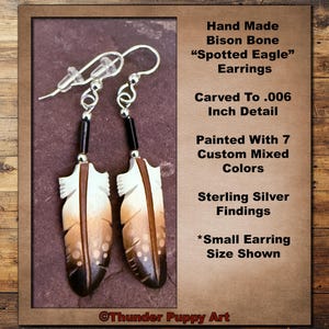 May include: Hand-carved bison bone earrings featuring a spotted eagle design. The earrings are painted with seven custom mixed colors and have sterling silver findings. The earrings are shown in the small size.