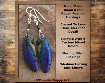 May include: Handmade bison bone raven feather earrings. The earrings feature carved feather pendants painted with six custom mixed colors. Sterling silver findings are used. The text on the image says "Medium Earring Size Shown".