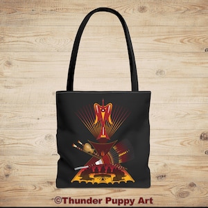 May include: A black tote bag with a red, yellow, and orange design featuring a stylized bird and geometric shapes. The text "Thunder Puppy Art" is printed on the bottom of the bag.