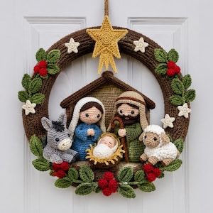 May include: A crocheted wreath featuring a brown circular base decorated with green leaves, red berries, and small white stars. A yellow star hangs at the top. In the center, a nativity scene includes figures of Mary, Joseph, a baby, a donkey, and a sheep.