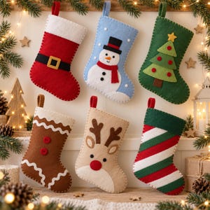 May include: Six felt Christmas stockings hanging in two rows. The top row features a red stocking with a black belt, a light blue stocking with a snowman, and a green stocking with a tree. The bottom row has a brown gingerbread stocking, a tan reindeer stocking, and a red, white, and green striped stocking.