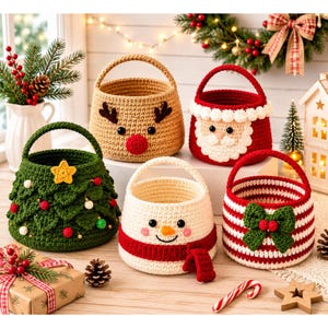 May include: Five round crochet baskets featuring holiday designs: a green Christmas tree with ornaments, a tan reindeer with a red nose, a red Santa Claus with a white beard, a white snowman with a red scarf, and a red and white striped basket with a green bow.