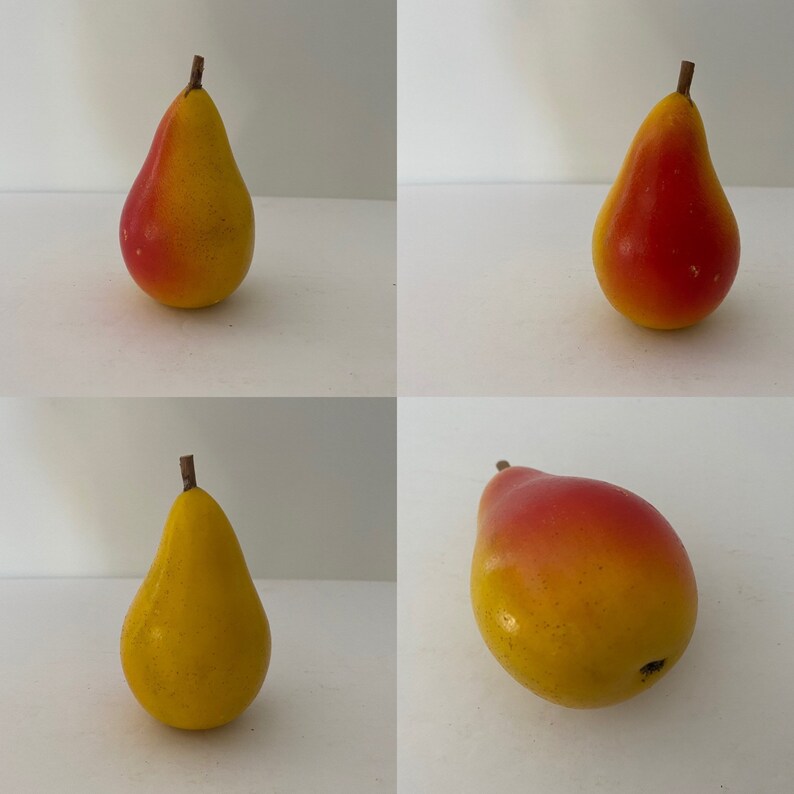 May include: Four yellow pears with red blush. The pears are arranged in a grid pattern on a white background.