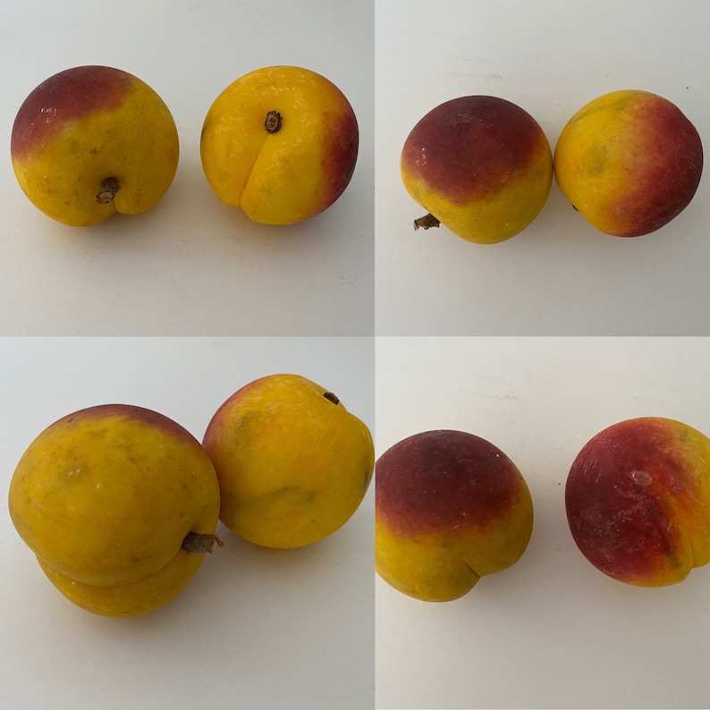 May include: A group of six yellow and red peaches. Some peaches have a red blush on one side. The peaches are arranged in two rows of three.