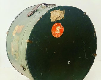 May include: A vintage green hat box with a leather handle and a red and white sticker that says "Cunard Line First Class S".