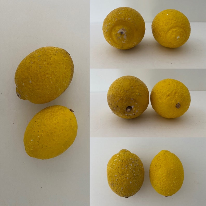 May include: A collection of nine yellow lemons, some with a slight green tint, arranged in three rows. The lemons have a textured surface and are slightly misshapen.