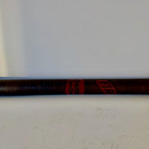 May include: A rolled up brown and red poster tube with the word "FIRE" printed in red on the side.