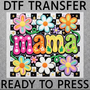 May include: A colorful DTF transfer with the word "mama" in a bubble letter style, surrounded by flowers. The flowers are in various colors, including pink, orange, yellow, and blue. The text "READY TO PRESS" is at the bottom.