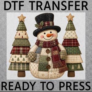 May include: A DTF transfer ready to press featuring a central snowman wearing a black top hat and a red plaid scarf, flanked by two stylized Christmas trees. The snowman and trees have a quilted patchwork design in shades of red, green, and cream.