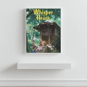 May include: A framed print with the title "Whisper of the Heart" in yellow. The image shows a traditional Japanese building with people in a green forest setting. The print is displayed on a white shelf, against a white wall.