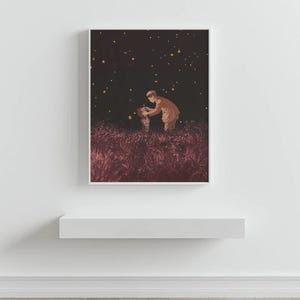 May include: A framed art print depicts two figures in a field under a starry night sky. The figures are in the center, with one appearing to assist the other. The field is a deep red-purple, and the sky is dark with scattered yellow lights.