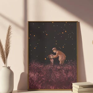 May include: A framed art print featuring an illustration of two figures in a field of tall, red grass under a dark sky with glowing orbs. The figures are dressed in warm-toned clothing, with a gold frame.