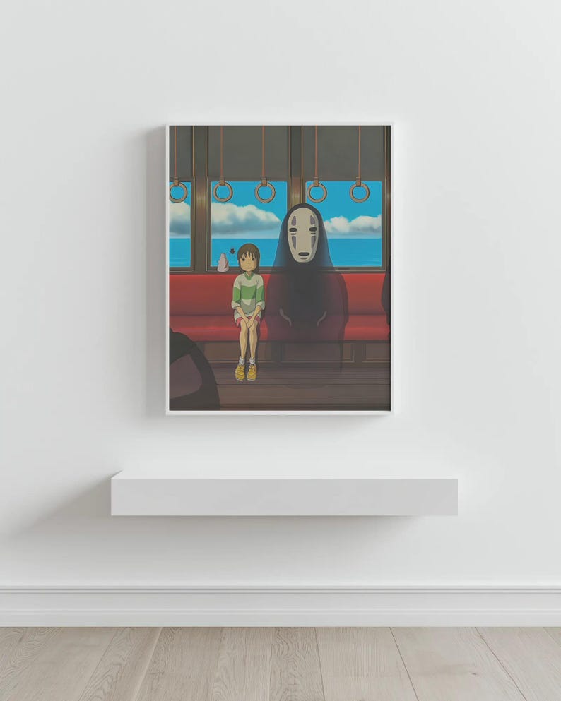 May include: Framed art print featuring a scene from an animated film. A young person in a green and white striped shirt sits on a red bench next to a tall, dark figure with a white mask. The background shows a blue sky and ocean.