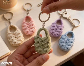 May include: A collection of handmade crochet bag keychains in various pastel colors: cream, pink, green, purple, and blue. Each keychain features a small, detailed bag design with a silver keyring. The image includes the text "INSTANT DOWNLOAD PDF".