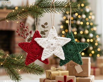 May include: Three handmade crochet star ornaments in red, white, and dark green, each hanging from a natural jute twine loop. These textured, five-pointed star decorations are crafted with yarn and feature a central circular pattern design.