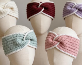 May include: A collection of handmade crochet headbands in various colors, including cream, burgundy, lavender, mint green, and pink. Each headband features a twisted knot design and a white border. The headbands are displayed on mannequin heads.