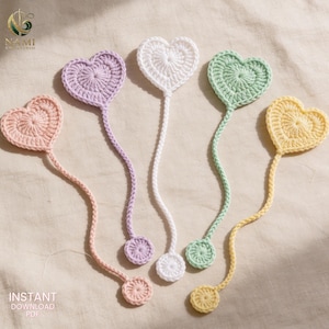 May include: Five crochet heart bookmarks in pastel colors including peach, lavender, white, mint green, and yellow. Each bookmark features a heart-shaped top connected to a long, thin crocheted cord ending in a small, circular crocheted disc.