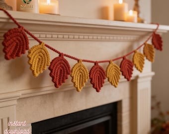 May include: A crocheted leaf garland in shades of orange and yellow, strung together with a red yarn. The garland is displayed above a fireplace, with candles in the background. The text "instant download pdf" is in the lower left corner.