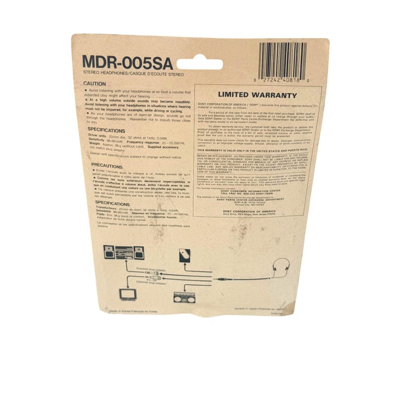 May include: A tan cardboard backing for Sony MDR-005SA stereo headphones. The card features black text including specifications, caution warnings, and a limited warranty. A diagram at the bottom illustrates connection points for the headphones.