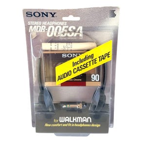 May include: Sony MDR-005SA stereo headphones in original blister packaging. The package includes a 90-minute audio cassette tape and a headphone jack adapter. The text on the packaging reads Sony, Stereo Headphones, MDR-005SA, for Walkman, and Including AUDIO CASSETTE TAPE.