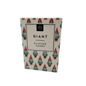 May include: A box of "GIANT PLAYING CARDS" with a white background and a repeating pattern of gnomes wearing red hats and blue jackets. The text "GIANT" is in a black box with a cross-like design above it.