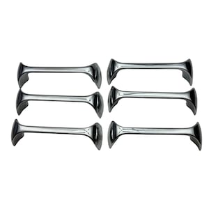 May include: Six polished chrome cabinet pulls. Each pull has a bow tie shape with a curved handle and flared ends. The pulls are arranged in two rows of three against a white background. Hardware for furniture.
