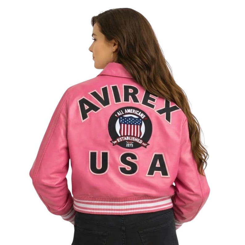 May include: A set of three ceramic mugs with a speckled, cream-colored glaze. Each mug features a different hand-painted design: a blue and green leaf, a yellow flower, and a red berry. The mugs have a simple, rounded shape.