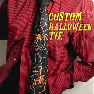 May include: A black necktie featuring an orange spider and white web pattern, worn with a red pinstriped button-down shirt. The text CUSTOM HALLOWEEN TIE is printed in yellow on the right side of the image against the red shirt fabric.