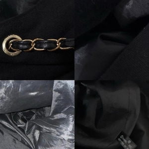 Puede incluir: Un bolso negro con una cadena de metal dorado entrelazada con cuero negro. El interior est&aacute; forrado con tela negra e incluye una etiqueta rectangular negra con el texto blanco CHANEL INC. NEW YORK, NY 56010 impreso en la superficie.