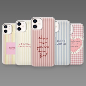 May include: Five phone cases with different designs. One case has a pink vertical stripe pattern with the text "slow down you are doing fine." Other cases feature text and patterns in pink, yellow, and blue.