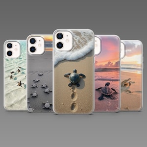 May include: A collection of five clear phone cases featuring images of sea turtles on a beach. The cases display turtles on sand, near ocean waves, and at sunset. The cases are designed to fit a smartphone.
