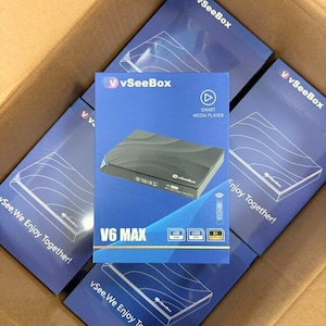 May include: A collection of blue boxes with the "vSeeBox" logo and the words "V6 MAX" printed on them. The boxes contain a black smart media player. The boxes are in a cardboard box.