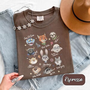 May include: A white ceramic mug with a black handle and the text "But First, Coffee" in a black, handwritten-style font. The mug is on a white surface.