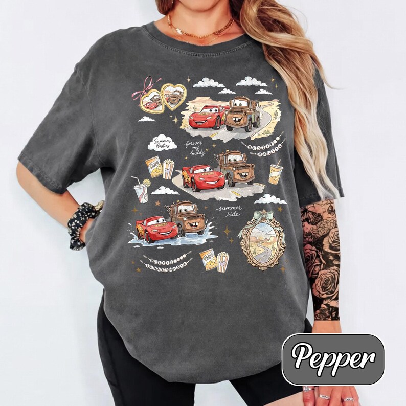 Puede incluir: Camiseta gris oscuro con un gr&aacute;fico de los personajes de Cars, Rayo McQueen y Mate. El dise&ntilde;o incluye el texto "Summer Sailing" y "Forever my buddy". La camiseta tiene un corte holgado.