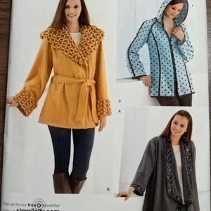 May include: Simplicity sewing pattern 2208 for jackets in sizes XS, S, M, L, and XL. The envelope displays three jacket variations: a mustard yellow jacket with textured trim, a light blue hooded jacket with black polka dots, and a gray open-front jacket.