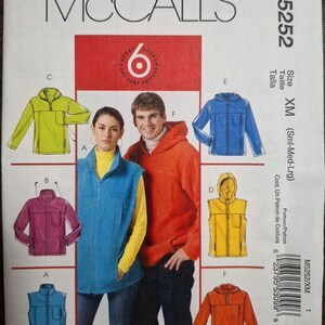 May include: A McCall's M5252 sewing pattern envelope for size XM, featuring illustrations of six different fleece jacket and vest designs in lime green, blue, magenta, yellow, and orange, with an MP3 player pocket feature.