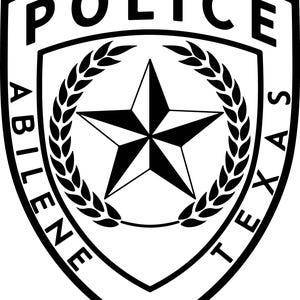 May include: Black and white police badge from Abilene, Texas. The shield-shaped emblem features the word "POLICE" at the top, with "ABILENE TEXAS" around the sides. A star is in the center, surrounded by a laurel wreath.