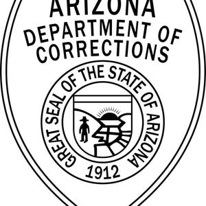 May include: Black and white Arizona Department of Corrections badge. The shield-shaped emblem features text that reads "Arizona Department of Corrections" and "Great Seal of the State of Arizona." The center seal includes a figure, sun, and mountains, with the year 1912.