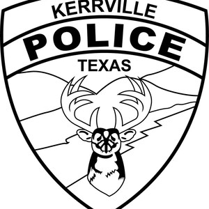 May include: A black and white shield-shaped emblem featuring the text KERRVILLE POLICE TEXAS at the top. The center of the shield displays a graphic illustration of a deer head with large antlers set against a background of rolling hills.