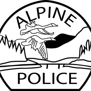 May include: Black and white Alpine Police badge. The badge features the word "ALPINE" at the top, with two flying geese above a mountain range and water. The word "POLICE" is at the bottom.