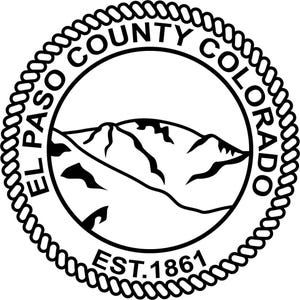 May include: A circular black and white emblem featuring a rope-style border. The text EL PASO COUNTY COLORADO is arched along the top, with EST. 1861 at the bottom. The center displays a graphic illustration of a mountain range with peaks.