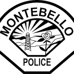 May include: A black and white emblem featuring the text MONTEBELLO at the top and POLICE at the bottom. The central design depicts a sunburst, a transmission tower, and a single rose on a stem, all enclosed within a shield-shaped border.