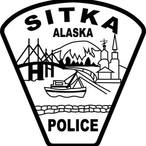 May include: A black and white shield-shaped emblem featuring the text SITKA ALASKA at the top and POLICE at the bottom. The central graphic depicts a bridge, a mountain, a boat, and buildings in a line art style with a thick black border.