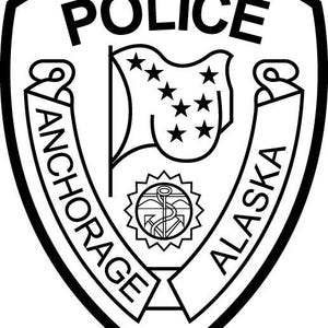 May include: Black and white police badge with the word "POLICE" at the top. The badge features a flag with stars, the words "ANCHORAGE" and "ALASKA", and a nautical emblem.