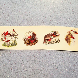 May include: Four illustrations of red cardinals in different settings. The first shows three cardinals on a branch with white flowers. The second shows two cardinals in a nest. The third shows two cardinals on a branch with a brown background. The fourth shows two cardinals on a branch with a brown background.