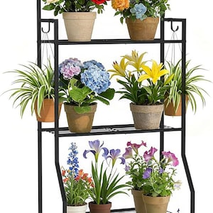 May include: A black metal plant stand with multiple shelves, displaying various potted flowers and plants. The stand features an arched top with climbing roses and a variety of colorful blooms, including roses, hydrangeas, and lilies.