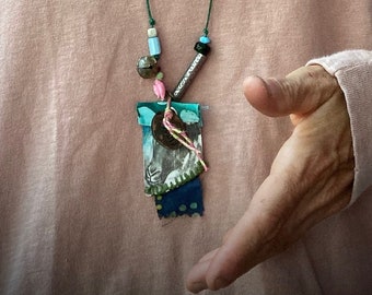 found-bit talisman: "kindness", with sheep, bell, denim and rose