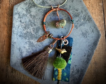 found-bit talisman:  hammered circle with chrysoprase, bird and tassel