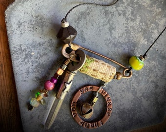 found-bit talisman: "magic words" with crystal, beads, bell, fabric and safety pin